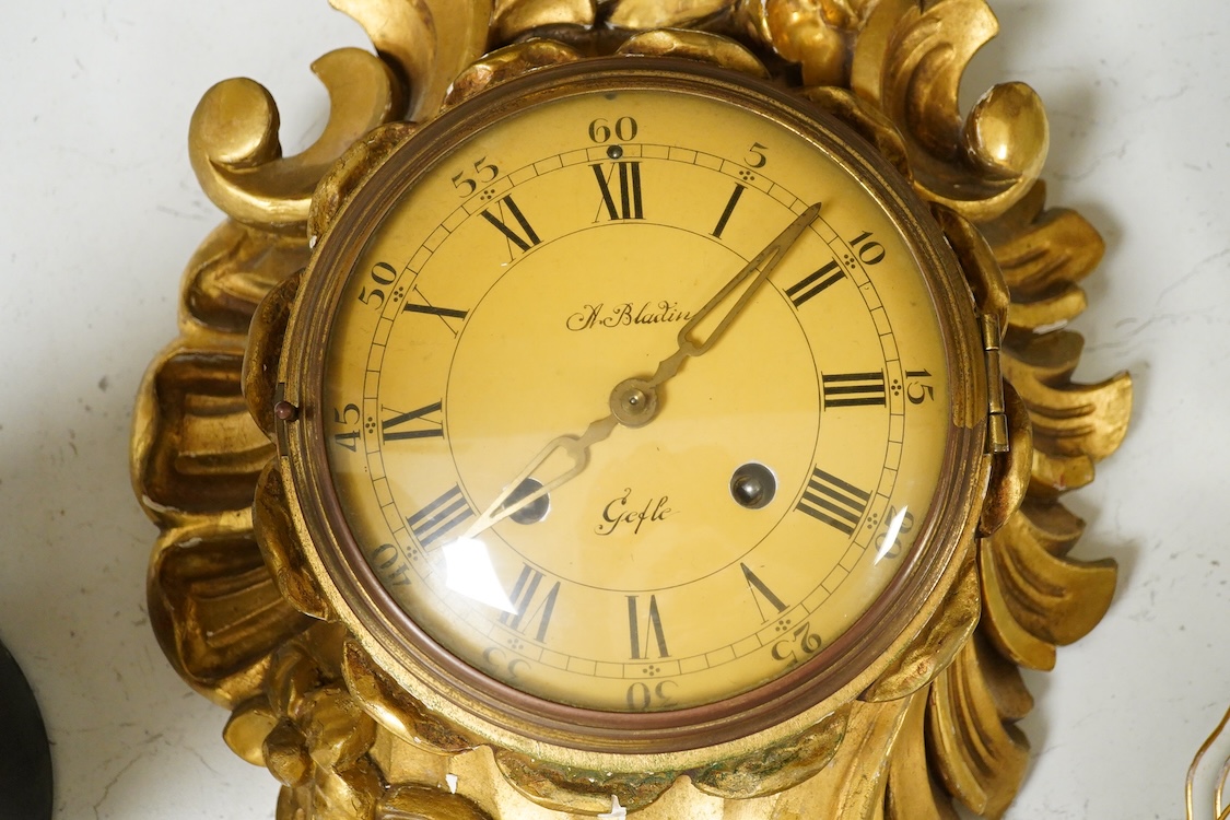 A carved giltwood cartel wall clock, 57 cm high